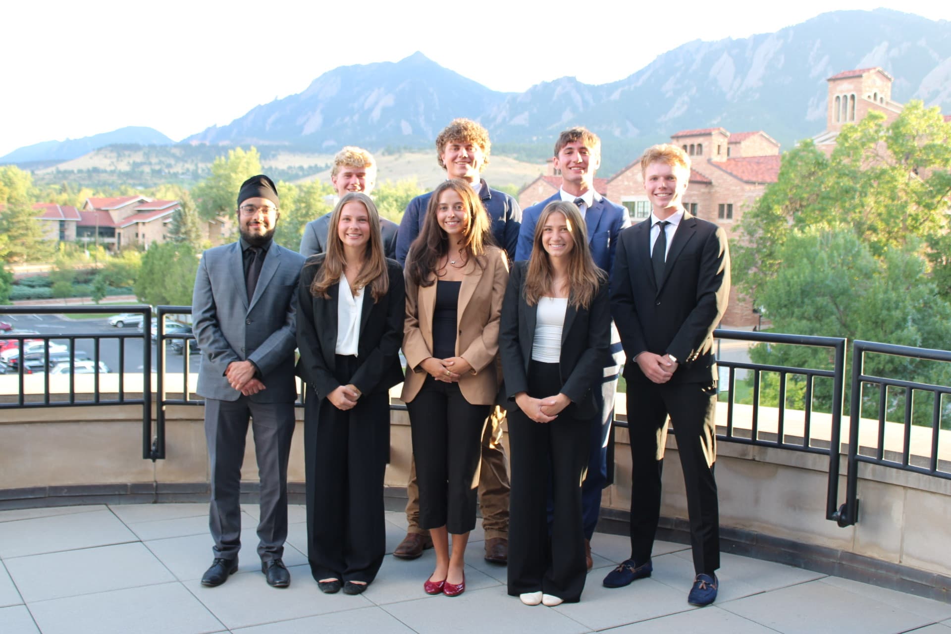 The Leeds Law Group executive board on campus at CU Boulder, with the Flatirons in the background